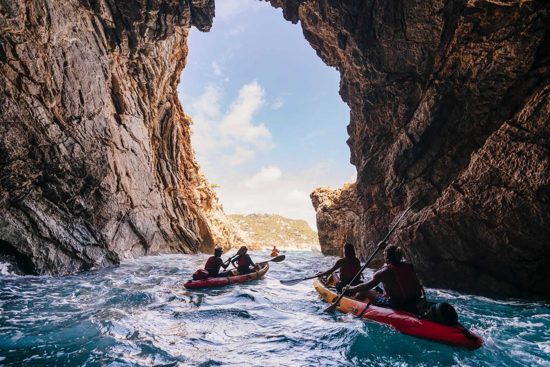 Sea kayaking through a marine cave on the coast of Es Figueral, Ibiza