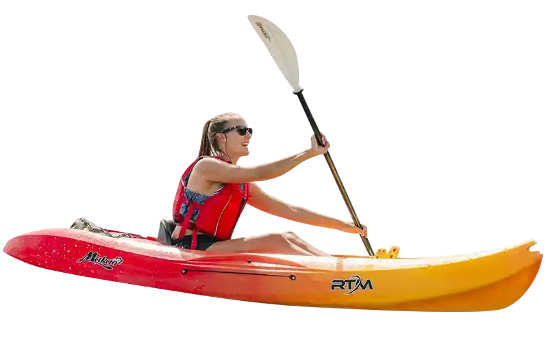 Woman with sunglasses paddling red and yellow kayak wearing life jacket during kayak and snorkel tour in Ibiza